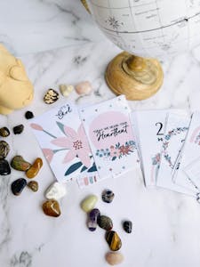 A calming still life of tarot cards and healing stones, perfect for spiritual and astrology themes.