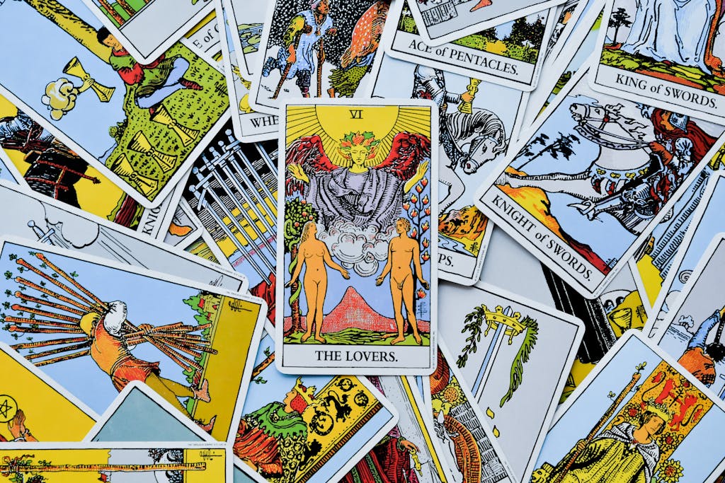 A colorful spread of various tarot cards with The Lovers card prominently displayed.