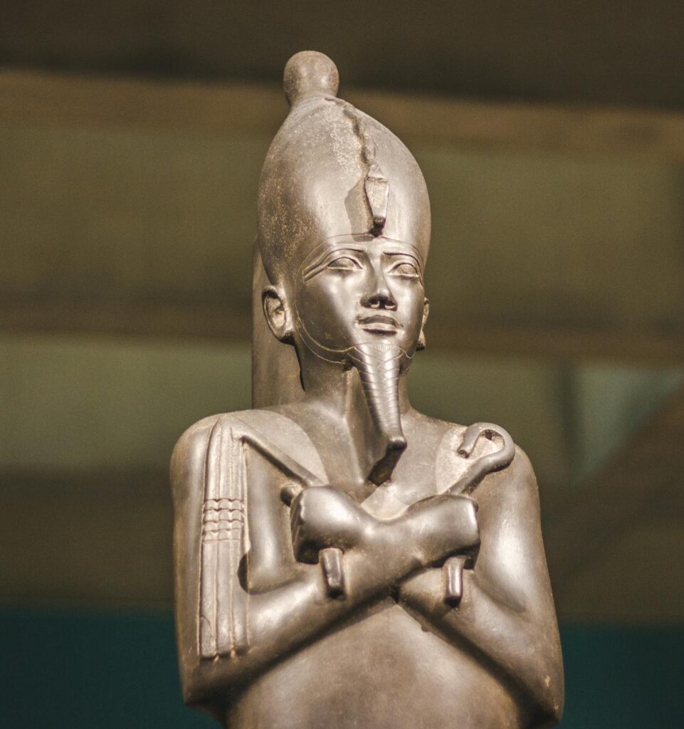 A detailed image of an ancient Egyptian statue displayed in a museum exhibit.
