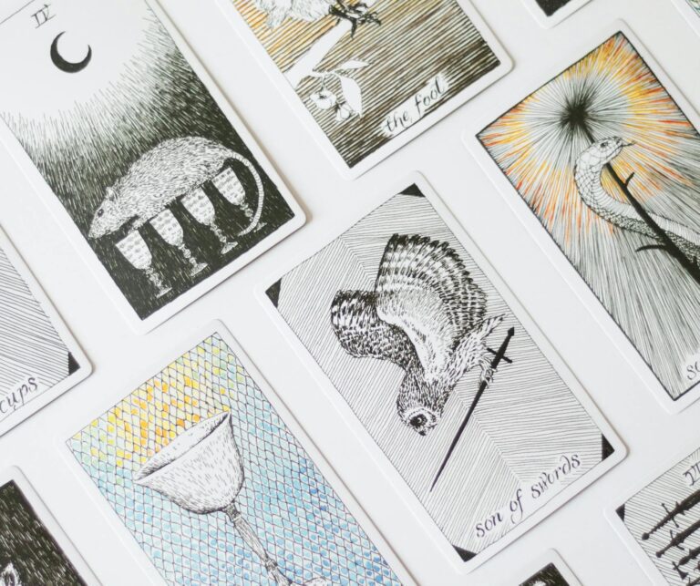A variety of tarot cards arranged creatively on a white backdrop, perfect for divination themes.