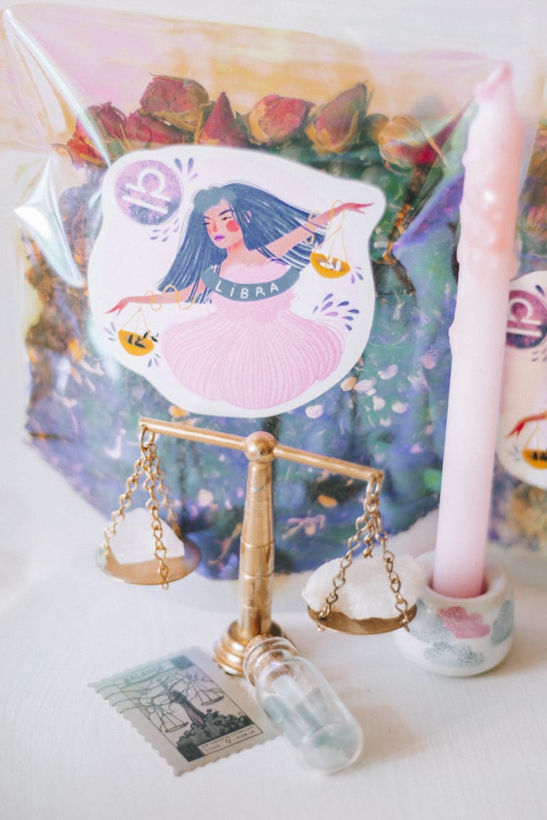 Aesthetic setup featuring Libra zodiac theme, candles, scale, and gemstones for a mystical ambiance.