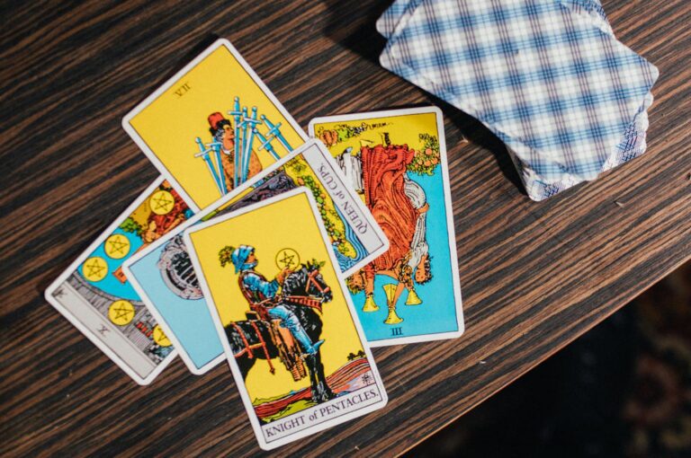 Intriguing tarot card spread on a textured wooden table, exuding mystical energy.