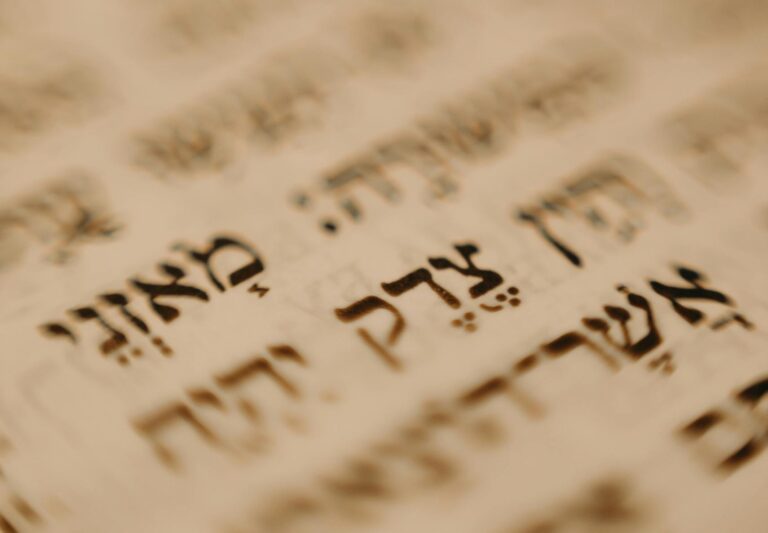 A detailed close-up of Hebrew text on a traditional religious document, emphasizing cultural significance.