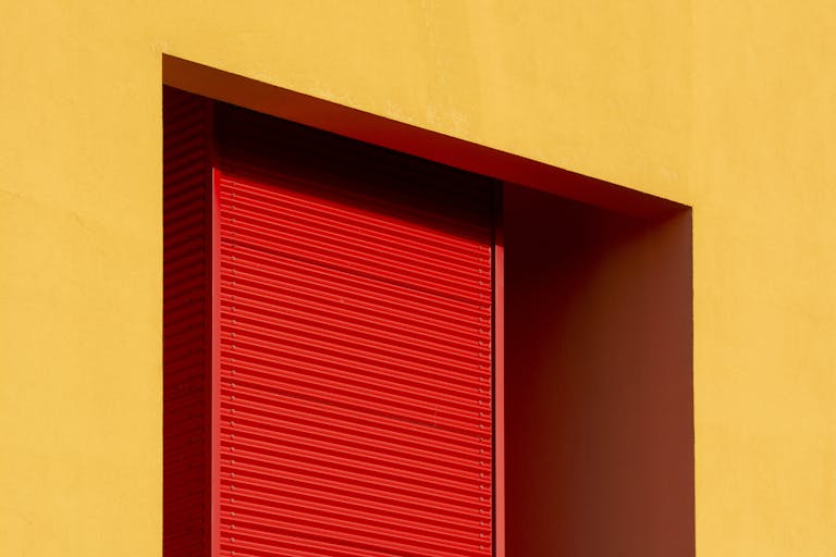 A striking abstract composition of red and yellow tones in an architectural structure.