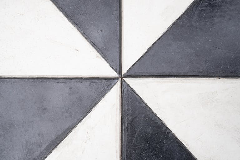 Abstract geometric pattern of black and white tiles with a modern design.