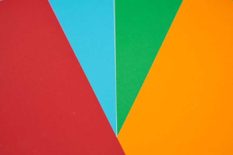 Colorful abstract design featuring red, blue, green, and orange geometric shapes.