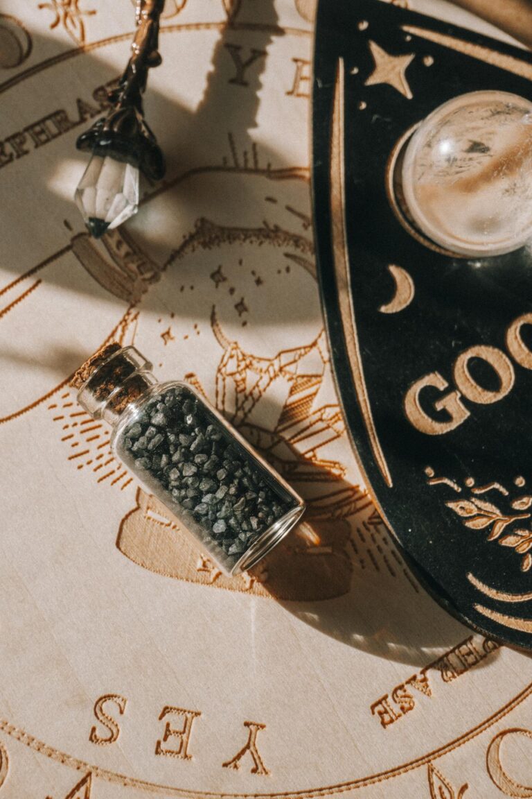 A glass bottle of black salt on an esoteric board with mystical symbols, captured in warm lighting.